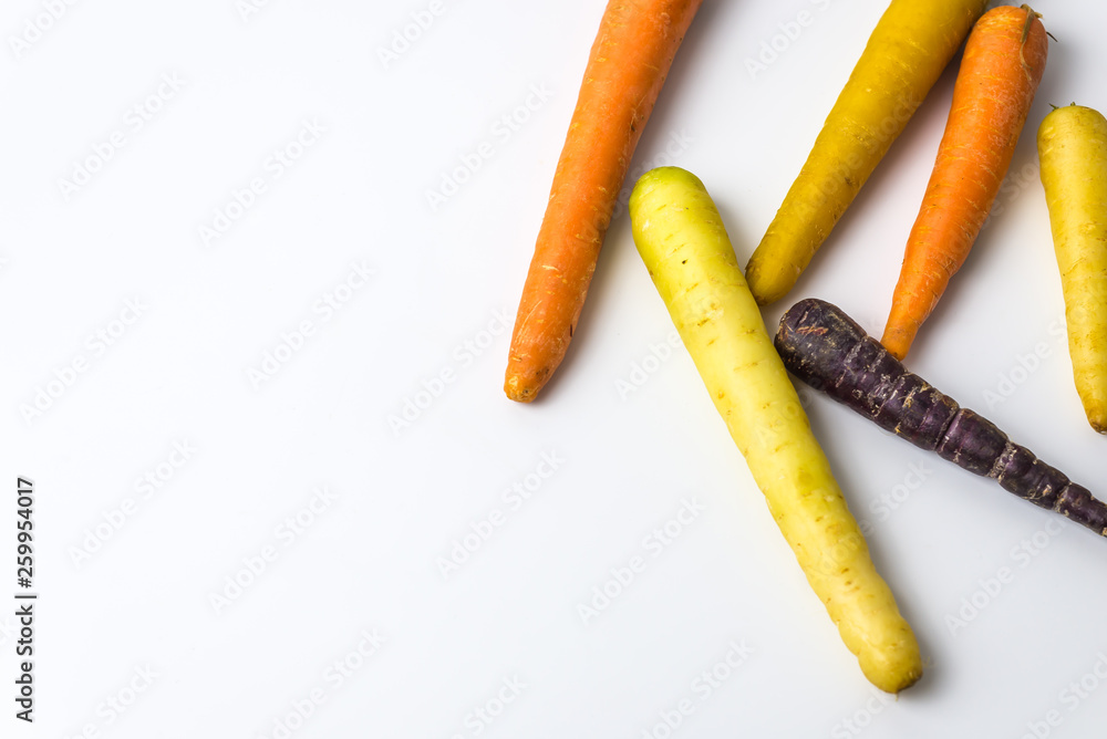 colourful organic carrots on white background colourful organic carrots on white background
