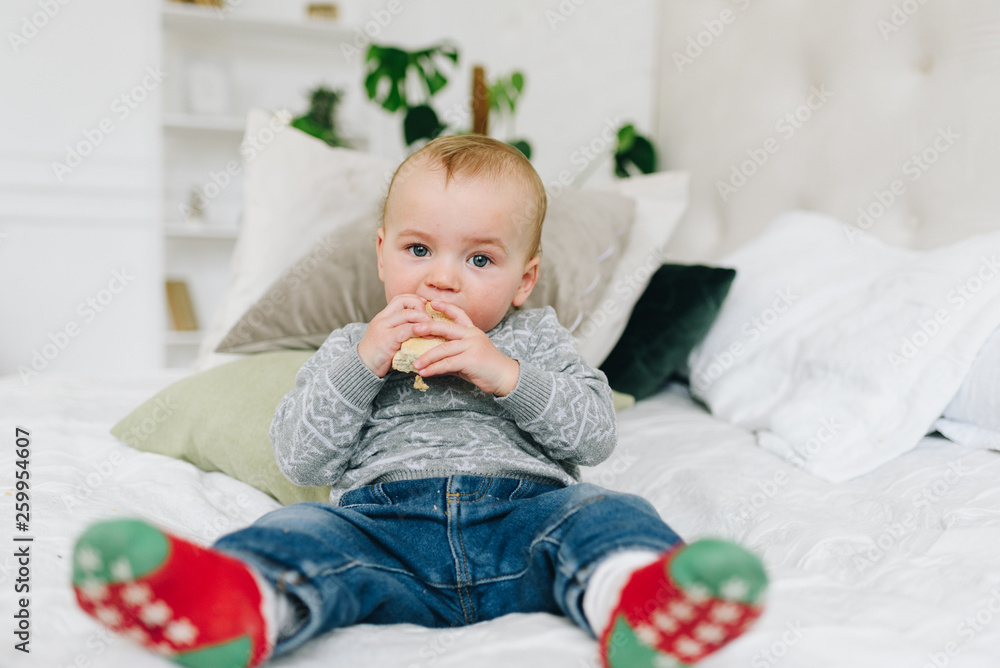 Very cute little toddler boy snacking. Baby or small child eating a piece of bread. Making funny silly face. Very cute little toddler boy snacking. Baby or small child eating a piece of bread. Making funny silly face.