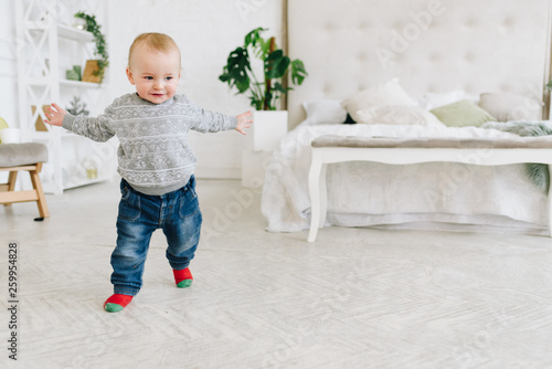 Cute little toddler boy taking the first steps