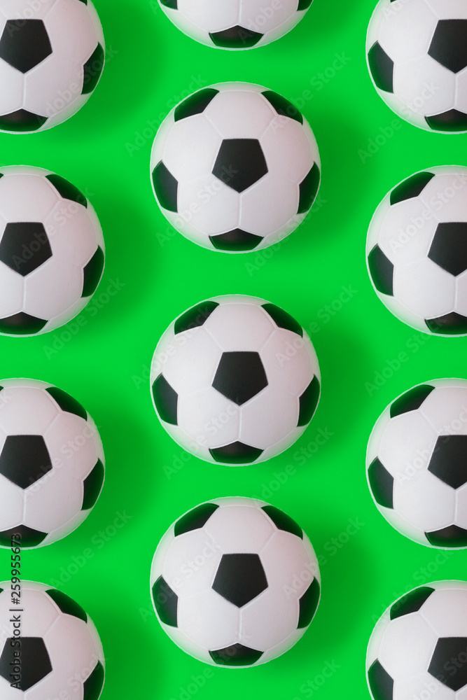 Naklejka premium Many black and white soccer balls background. Football balls in a water