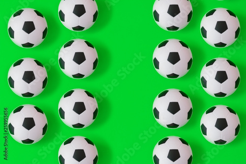 Many black and white soccer balls background. Football balls in a water