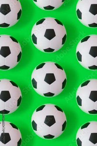 Many black and white soccer balls background. Football balls in a water