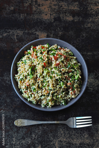 Salad tabbouleh. Healthy salad with bulgur and vegetables. Lebanese recipe. Middle Eastern cuisine.
