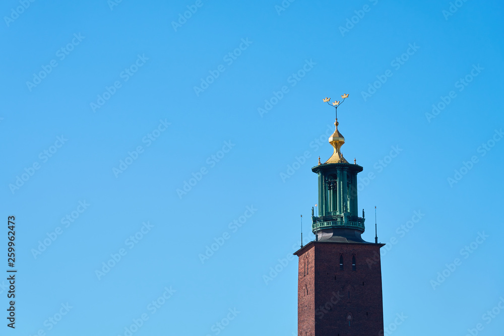 The tower of the city hall of Stockholm against a blue sky. Copy space. The tower of the city hall of Stockholm against a blue sky. Copy space.