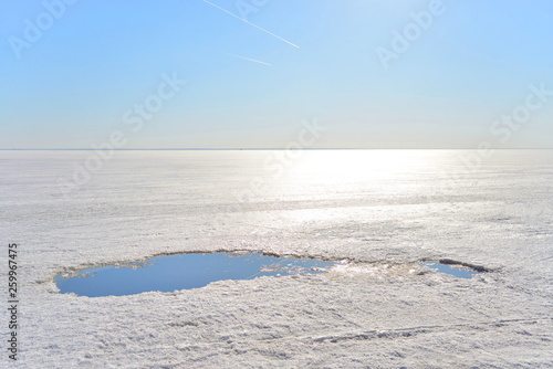 Frozen sea at sunny day.