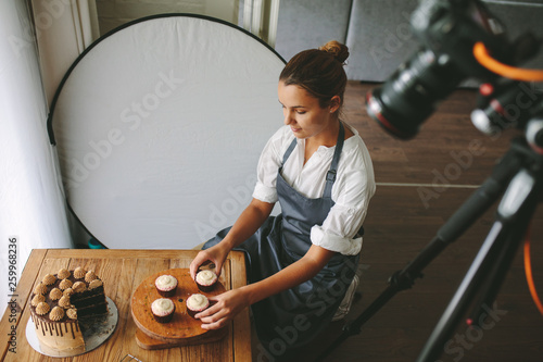 Feamle baker making a video blog photo