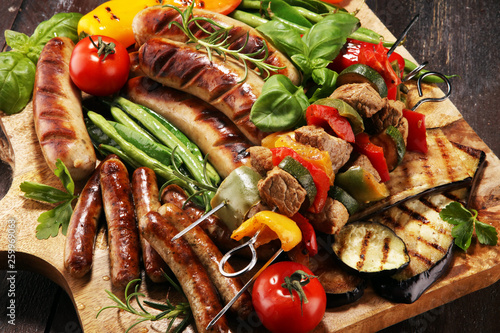 Assorted delicious grilled meat with vegetable on a barbecue. Grilled pork shish or kebab on skewers with vegetables . Food background shashlik