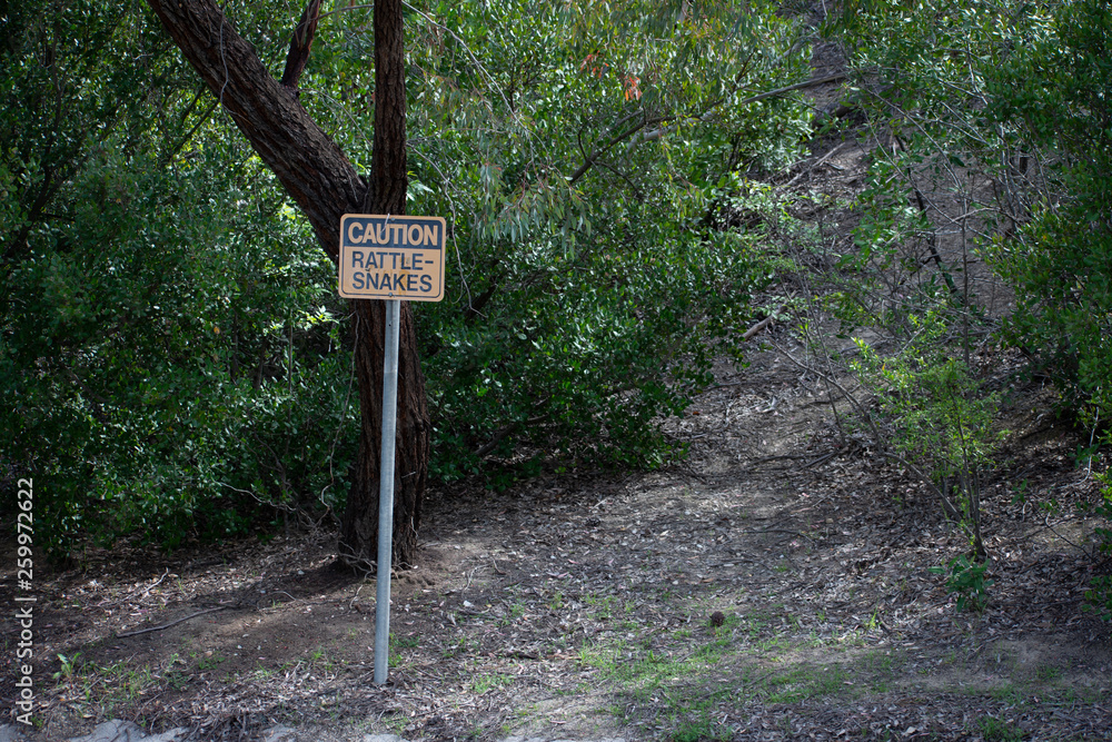 Rattlesnake warning/caution sign at park in West Hills, Los Angeles, California
