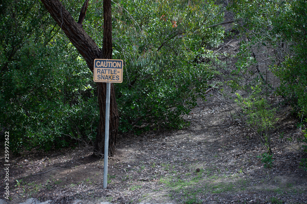 Rattlesnake warning/caution sign at park in West Hills, Los Angeles, California Rattlesnake warning/caution sign at park in West Hills, Los Angeles, California