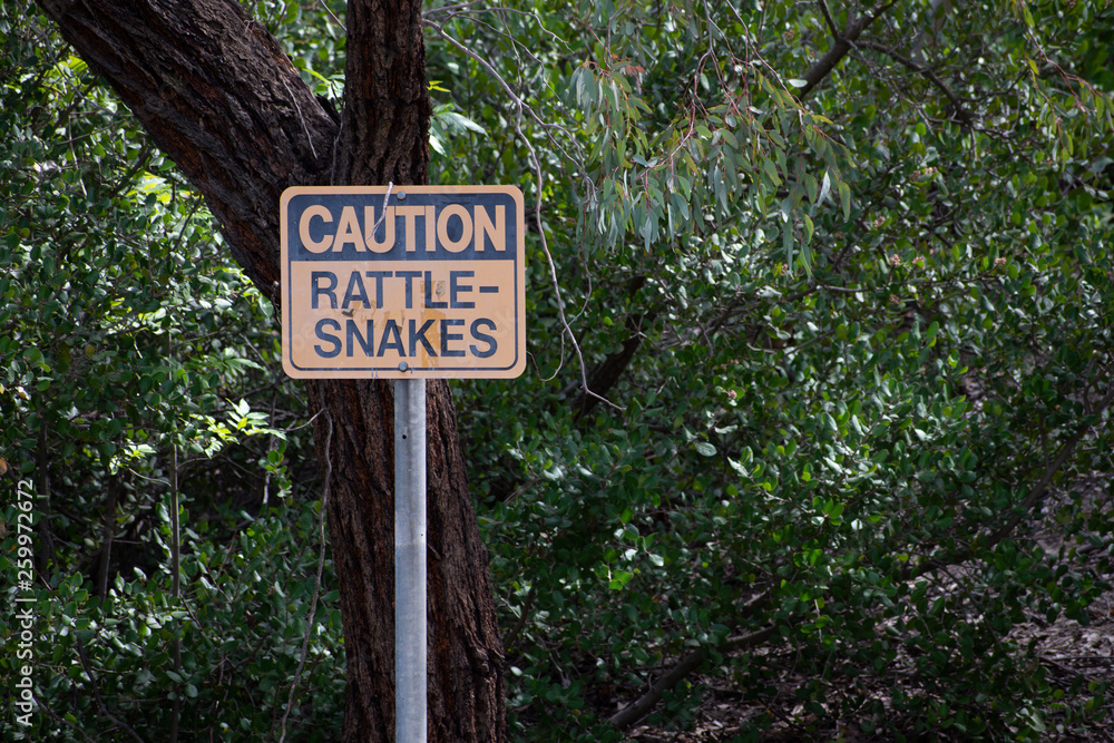 Rattlesnake warning/caution sign at park in West Hills, Los Angeles, California