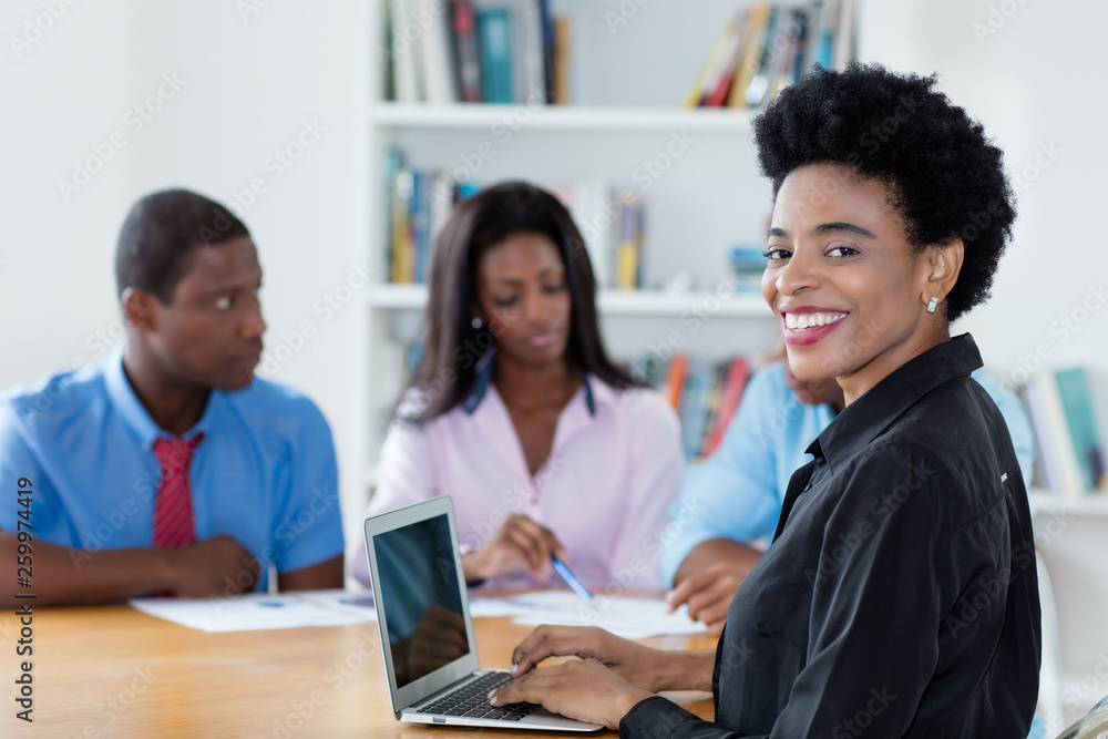 Smart african american businesswoman with team and computer Smart african american businesswoman with team and computer