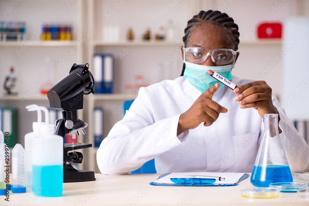 Young black chemist working in the lab Young black chemist working in the lab