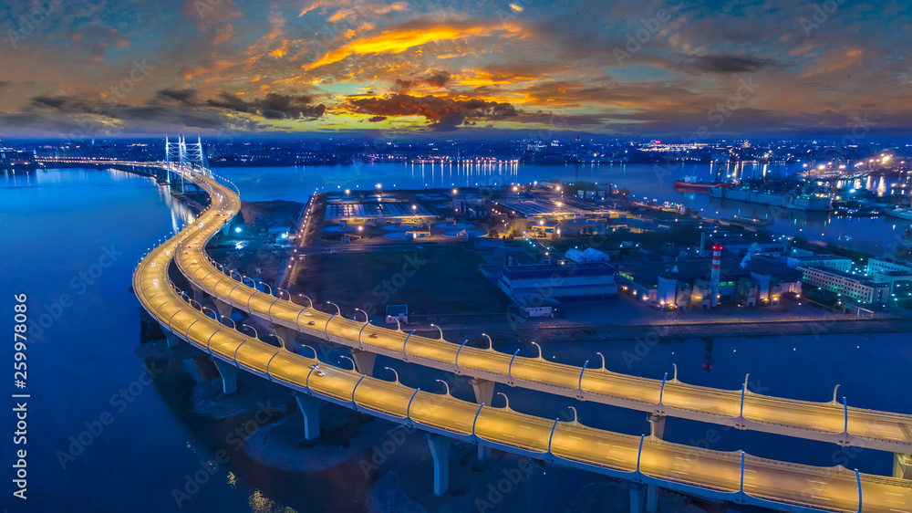 Saint Petersburg. Russia. Expressway on the evening Petersburg panorama. Illuminated speed highway. Petersburg transport interchanges. West speed diameter. Neva River. Cities of Russia.