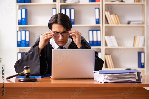 Young handsome judge working in court 