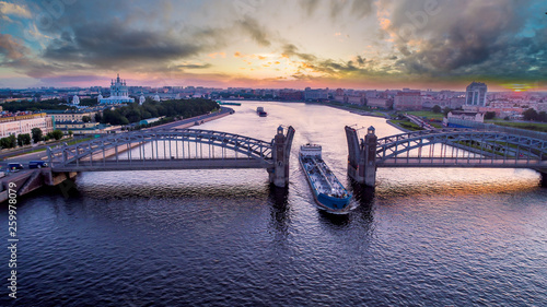 Saint Petersburg. Russia. Bolsheokhtinsky bridge lifted. Bridge of Peter the Great at sunset. The drawbridges of Petersburg. Navigation on the Neva River. Cities of Russia. Panorama of St. Petersburg.