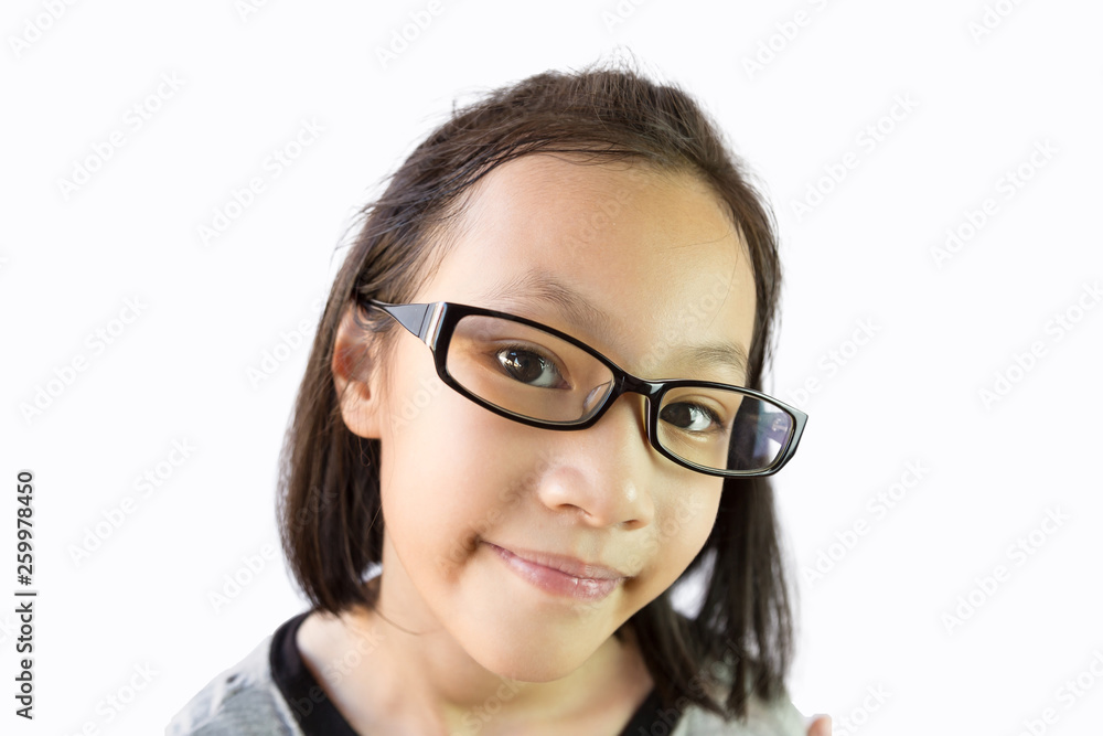 Close up asian little girl wearing eyeglasses isolated on white background,portrait of cute child holding glasses with hand and smiling,looking at the camera
