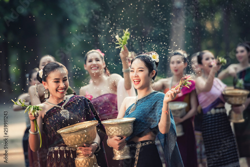 Vientiane Laos APRIL 4 2019 : Young happy beauty Asian woman splashing water during  Water Songkran festival ,Thailand Laos traditional. photo