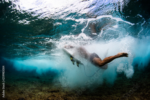 Underwater view of the surfer after wipe out in the tropical sea