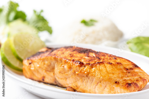 Grilled salmon steak with salad and rice