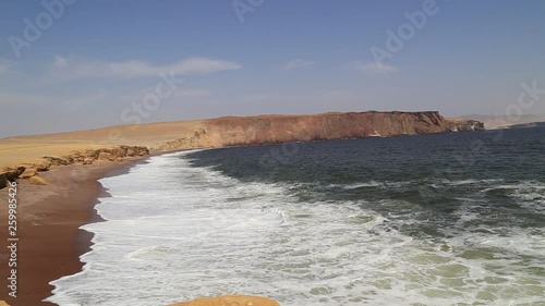 The coast and red sand beach of Paracas National Reserve in Peru. photo