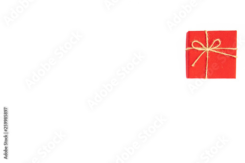 Red gift box tied with a rope tied into a bow isolated on a white background © wittaya