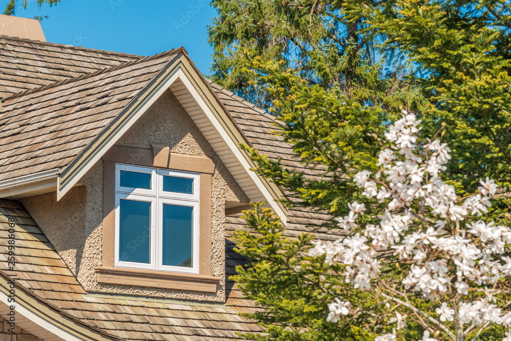 The top of the house or apartment building with nice window The top of the house or apartment building with nice window