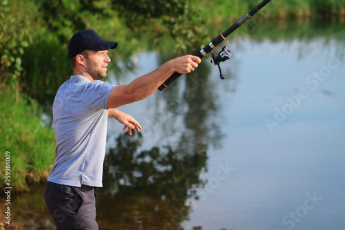 Man throws bait. Fisherman with fishing rod
