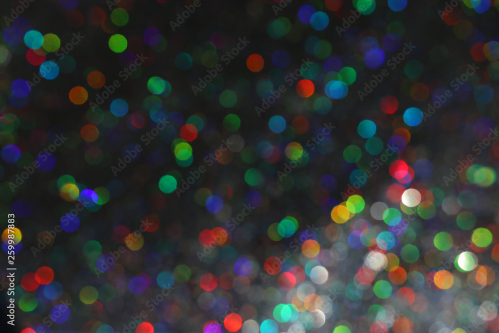 Naklejka premium glitter black lights background with colorful bokeh. de-focused