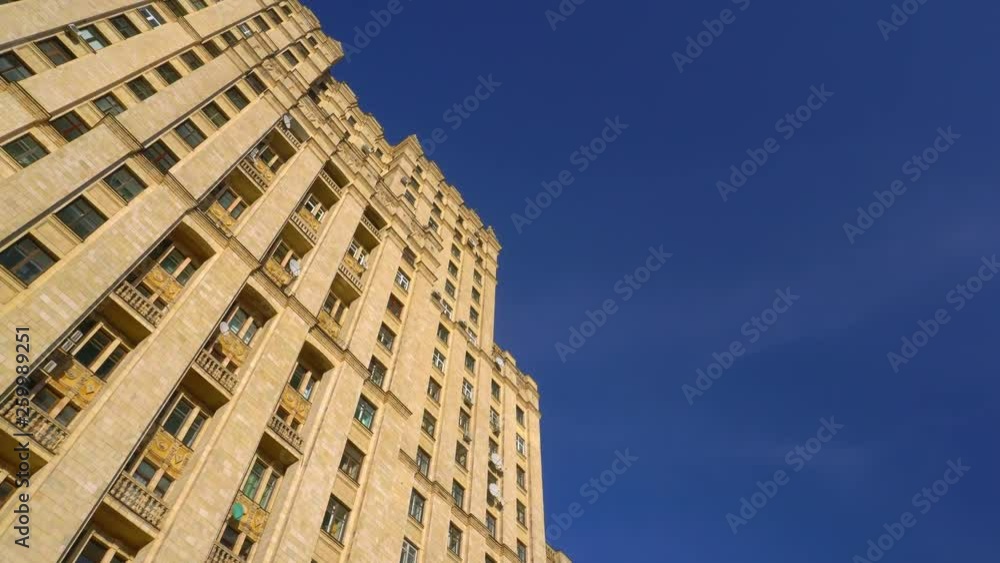 facade of the old Stalinist skyscraper. view from the bottom. Beautiful architecture Sculptures and stucco as elements of the decor of the building. Ultra HD stock footage facade of the old Stalinist skyscraper. view from the bottom. Beautiful architecture Sculptures and stucco as elements of the decor of the building. Ultra HD stock footage
