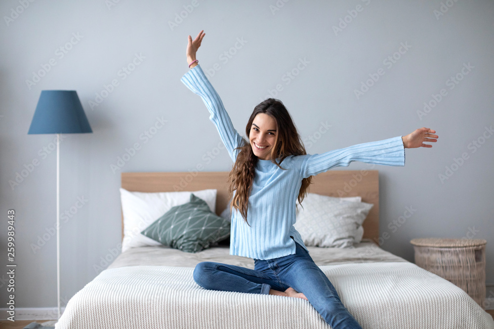 Nice woman enjoy sitting on the bed in the house. Nice woman enjoy sitting on the bed in the house.