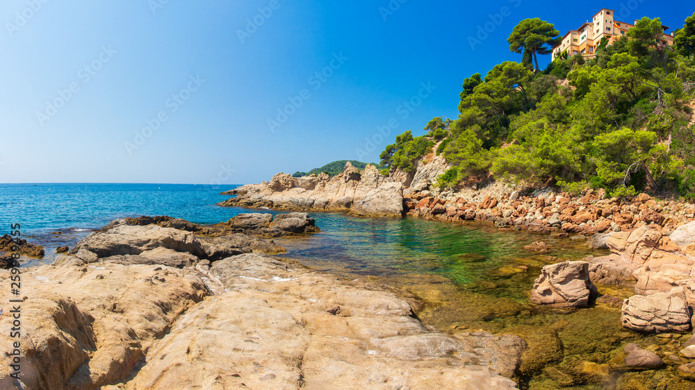 Spain sea landscape. Spanish coast with rocky beach on clear day