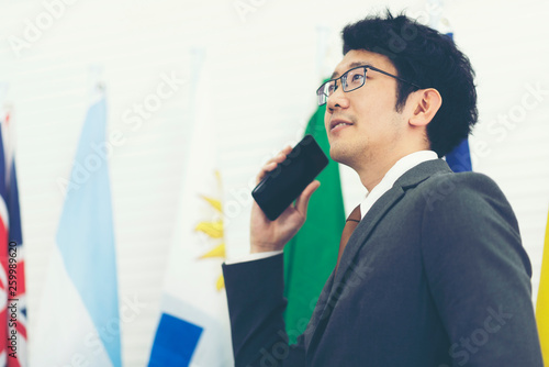 Asian businessman standing ...