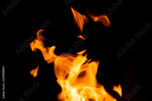 Fire isolated on black background. Isolated flame. Bright orange fire. Burning flame. Flames background. Fiery orange texture. Close up fire energy and motion. © Joshua