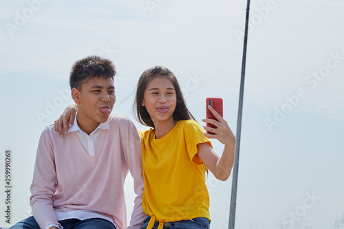asian couple taking a selfie outdoor