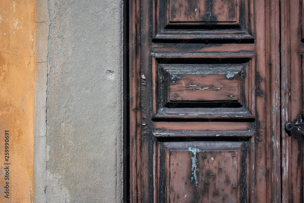 Background texture of an old brown wooden door and cement wall Background texture of an old brown wooden door and cement wall