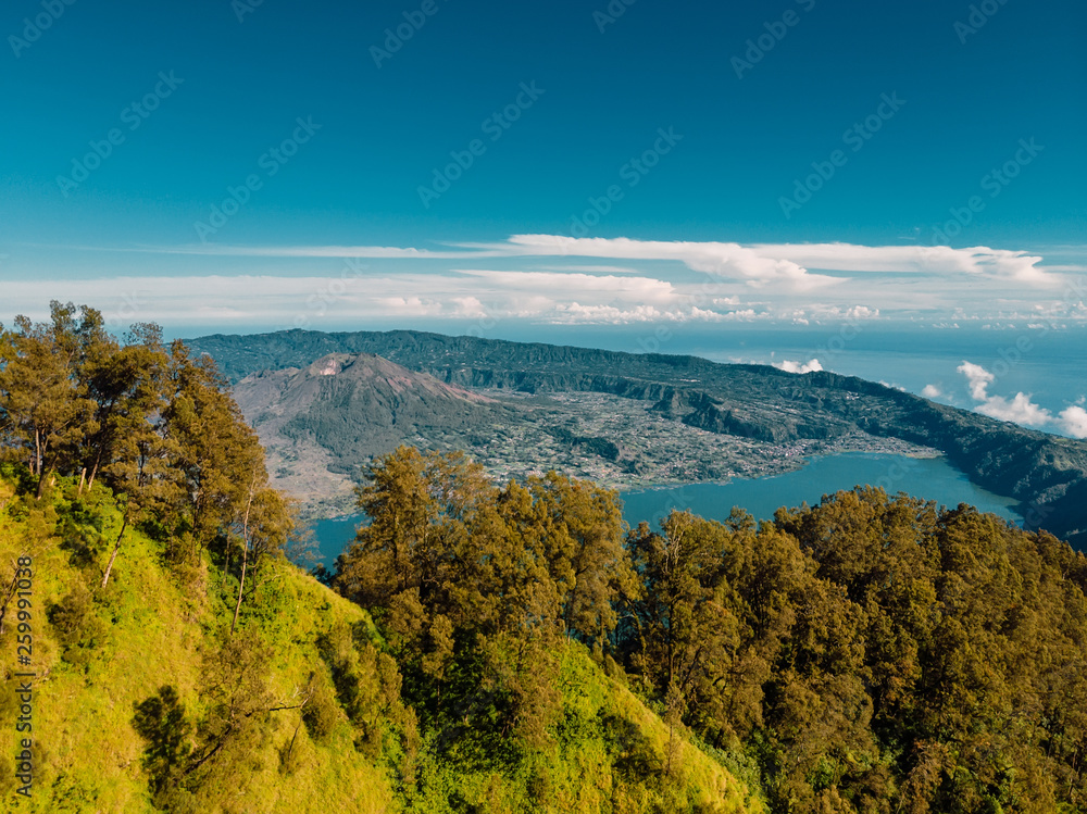 Aerial view of Batur volcano and lake with forest in Bali