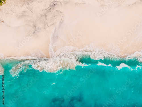Tropical sandy beach with turquoise ocean and waves. Aerial view