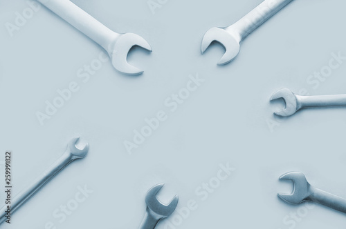 Tools: wrench on tinted light-blue background, copy space.Flat lay, top view. Tools for repair.Male set.