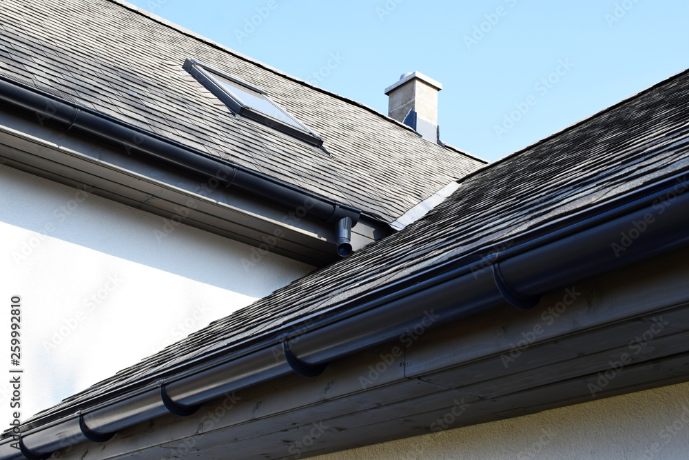 Grey asphalt shingles roof construction with ridge ventilation on