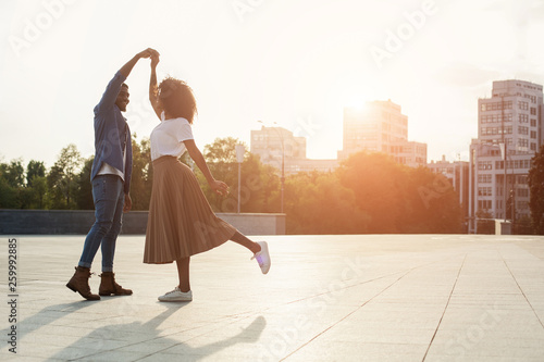Loving couple dancing at sunset on the street