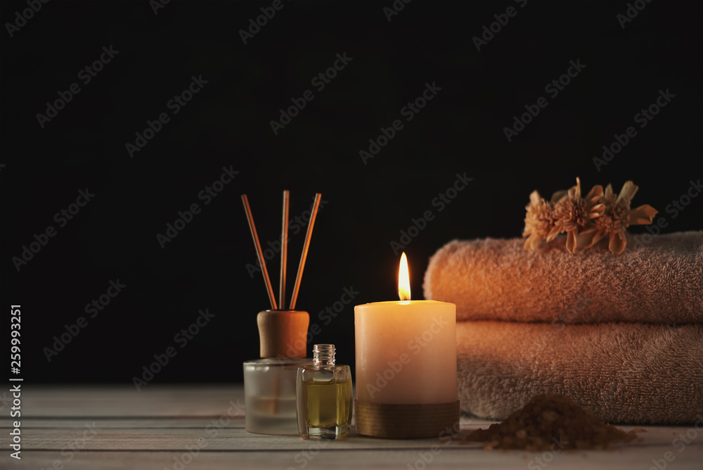 Towels, candle and massage oil on white table - obrazy, fototapety, plakaty 