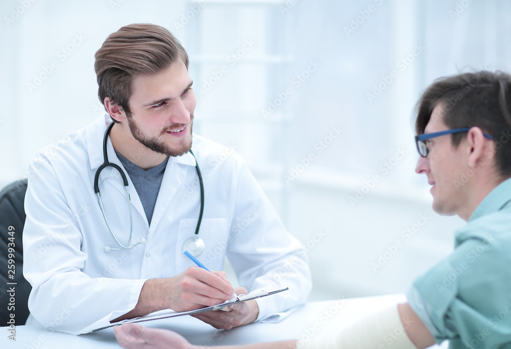 doctor writing a prescription to her patient,