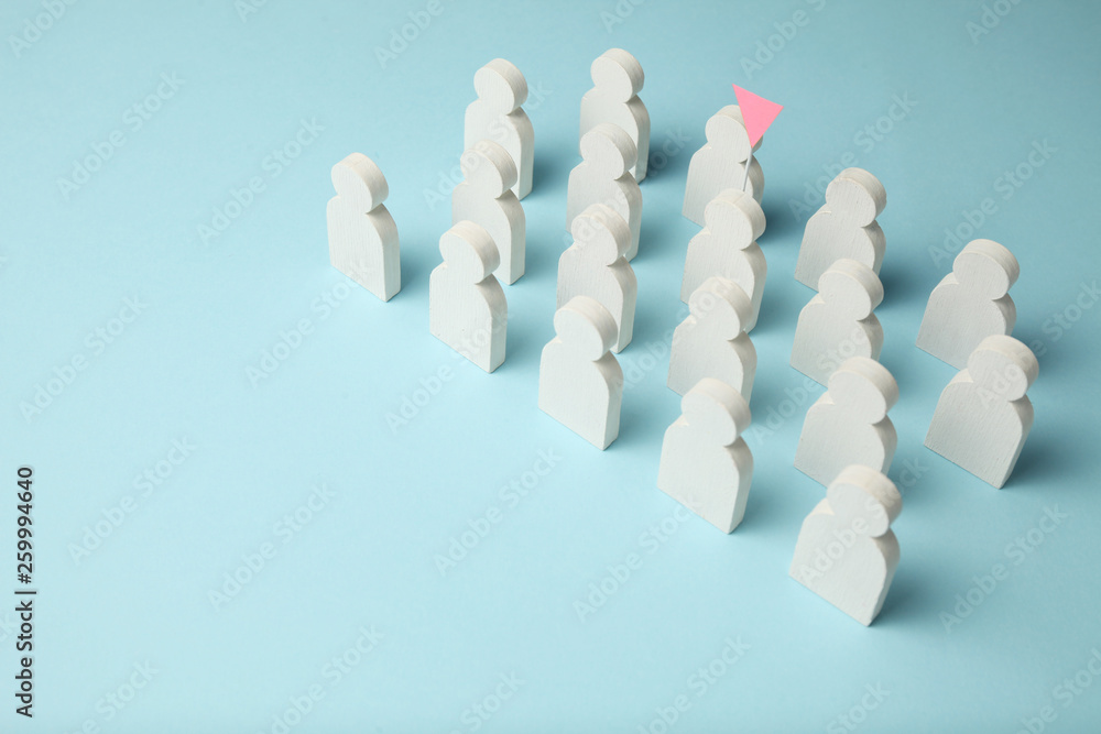 The best employee in the team. Competition, selection for the position. White figures of people on a blue background, business concept. The best employee in the team. Competition, selection for the position. White figures of people on a blue background, business concept.