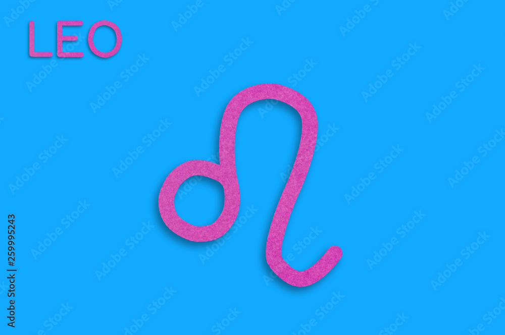 Symbol of astrological sign and word leo cut out of purple paper on blue table. Top view. Horoscope concept Symbol of astrological sign and word leo cut out of purple paper on blue table. Top view. Horoscope concept
