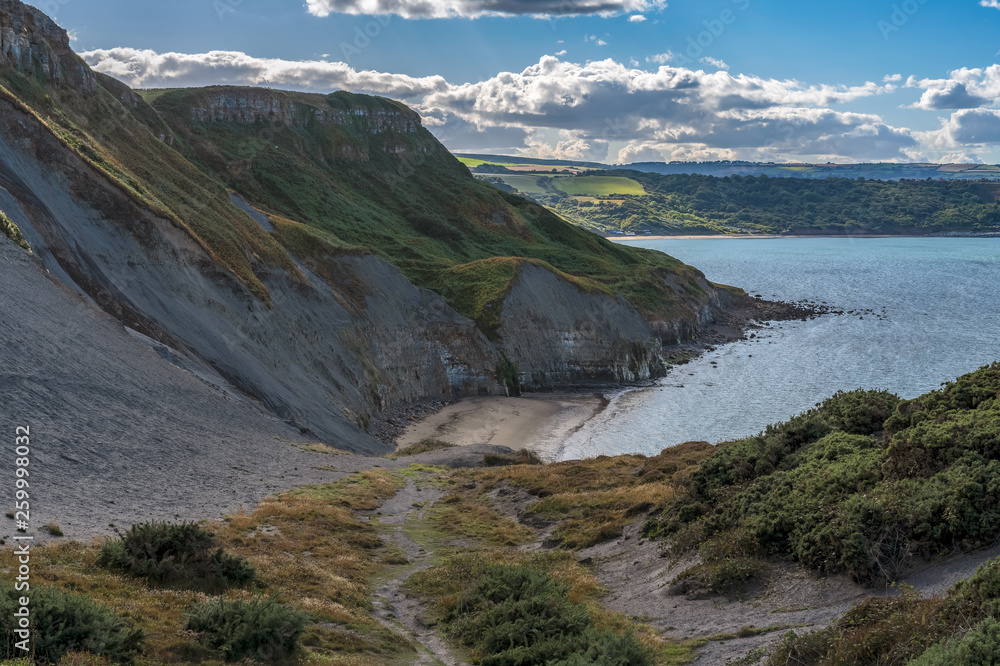North Sea Coast in North Yorkshire, England, UK - seen from the former alum quarry in Kettleness Point, looking towards Runswick Bay North Sea Coast in North Yorkshire, England, UK - seen from the former alum quarry in Kettleness Point, looking towards Runswick Bay