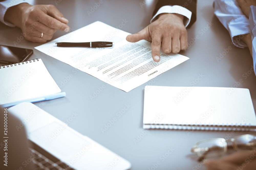 Group of business people at meeting discussing contract Group of business people at meeting discussing contract
