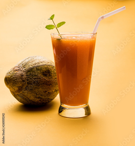 Musk melon juice with slice, also known as Kharbuj/kharbuja fruit extract, served in a glass with mint. selective focus photo