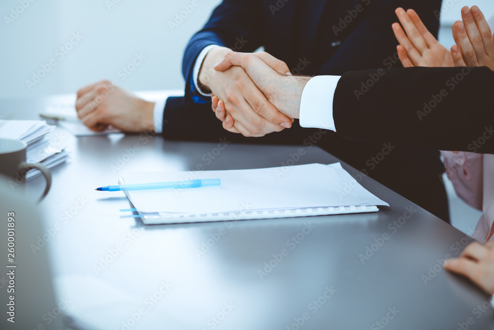 Business people shaking hands finishing up a meeting. Handshake at successful negotiation Business people shaking hands finishing up a meeting. Handshake at successful negotiation