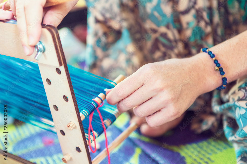 Hands weave belt in the Slavic style, the process of weaving a belt of cotton threads. Stock