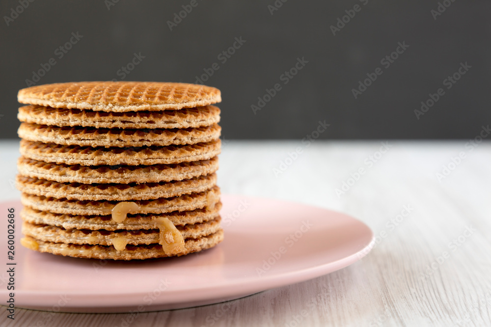custom made wallpaper toronto digitalStack of sweet Dutch stroopwafels with honey-caramel filling on pink plate, side view. Copy space.